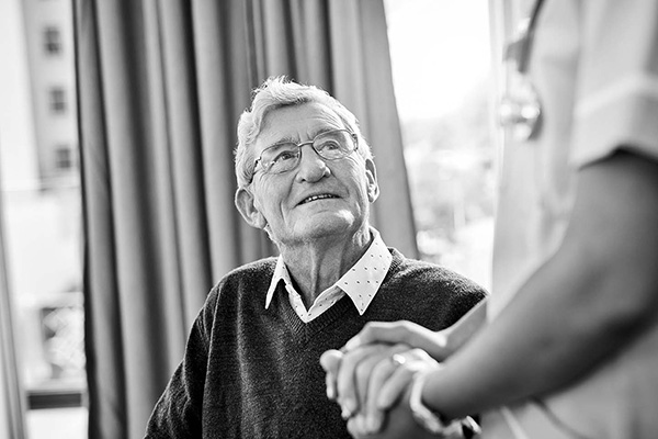 man holding hands with doctor