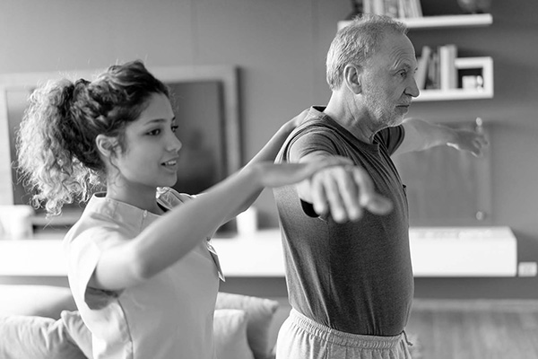 man stretching with nurse